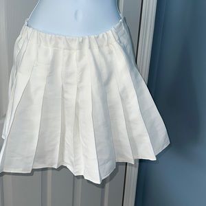Brand new white pleated skirt with attached shorts